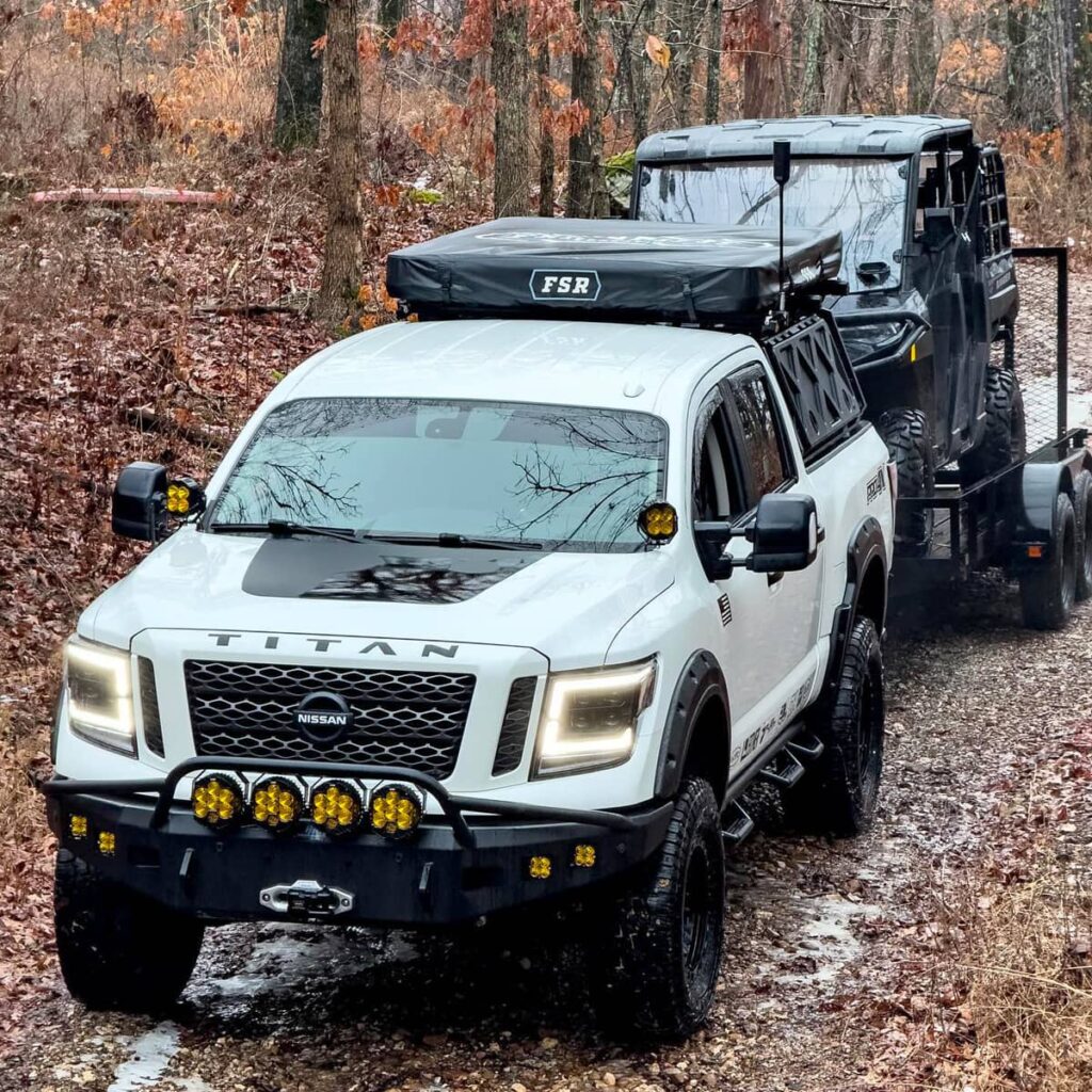 Modified 2019 Nissan Titan XD towing a trailer with ATV