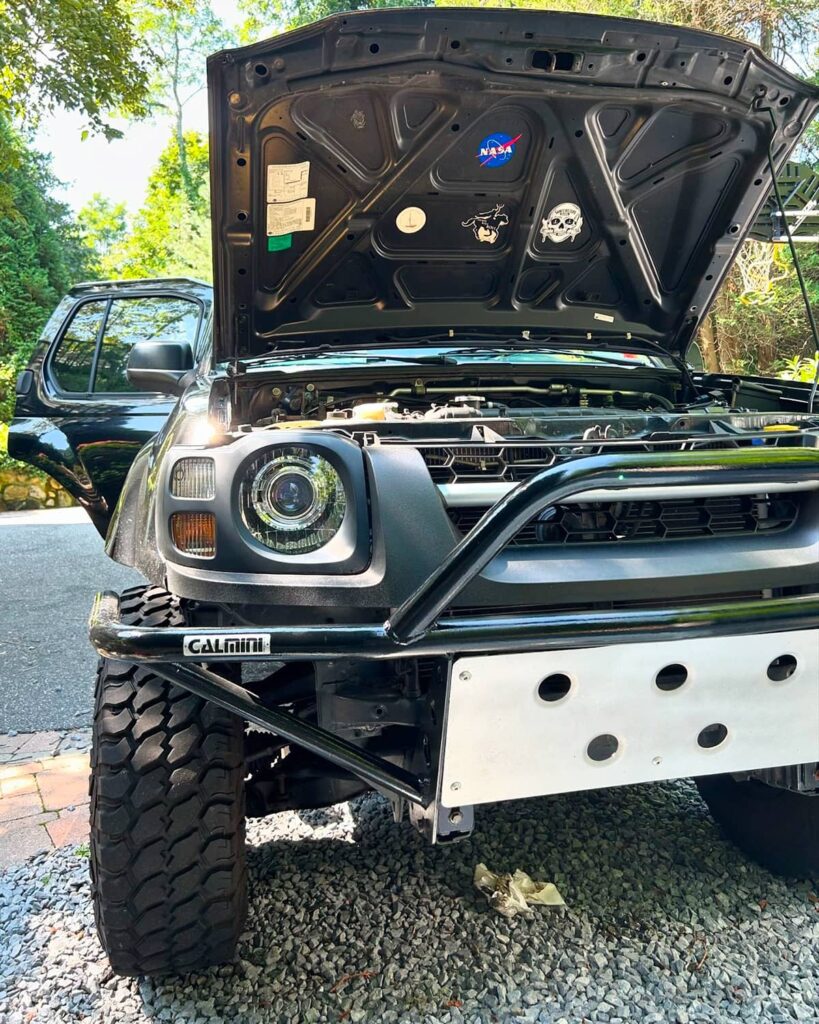 Calmini tubular front pre-runner bumper with a skid plate