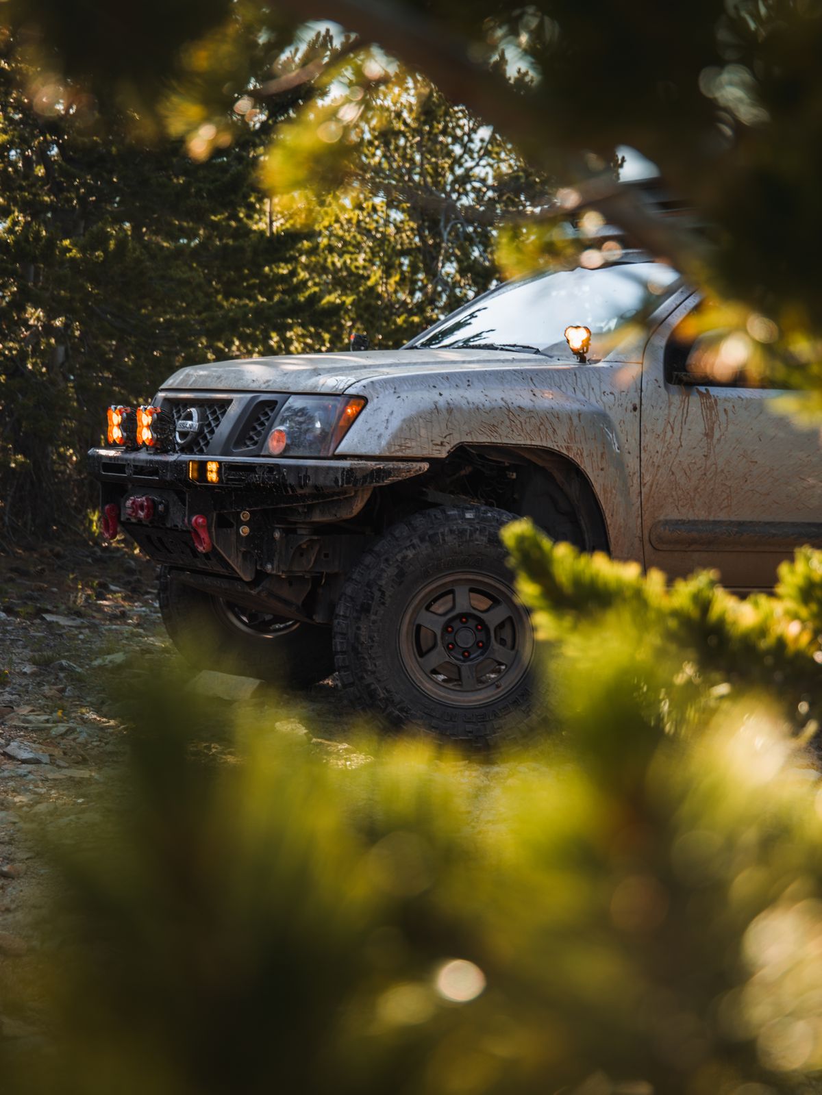 Silver 2nd Gen Nissan Xterra overlanding build on 35"s