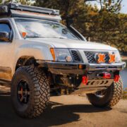 Z1 Offroad Titan UCA visible on the front axle of a muddy silver Nissan Xterra build