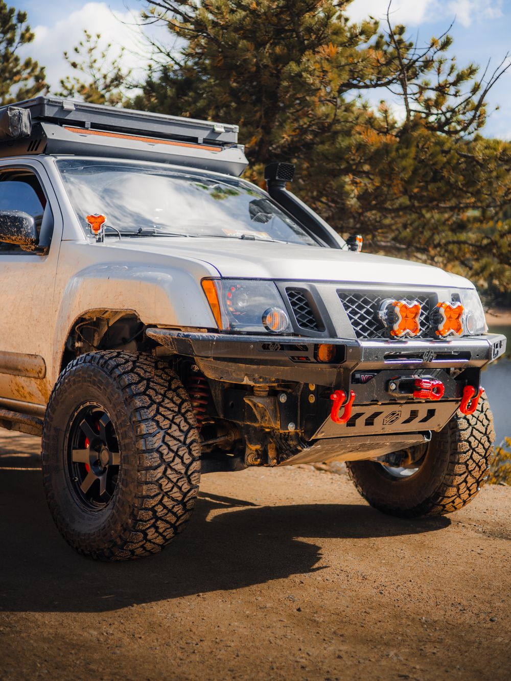 Z1 Offroad Titan UCA visible on the front axle of a muddy silver Nissan Xterra build