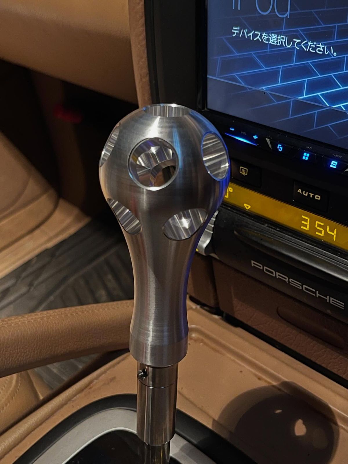 Billet aluminum shift knob of the Aisin automatic transmission inside the white 957 Porsche Cayenne built by AP Osaka