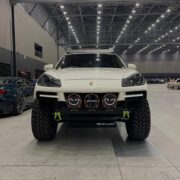 White lifted Porsche Cayenne with AP Osaka front bumper on display at a Japanese car show