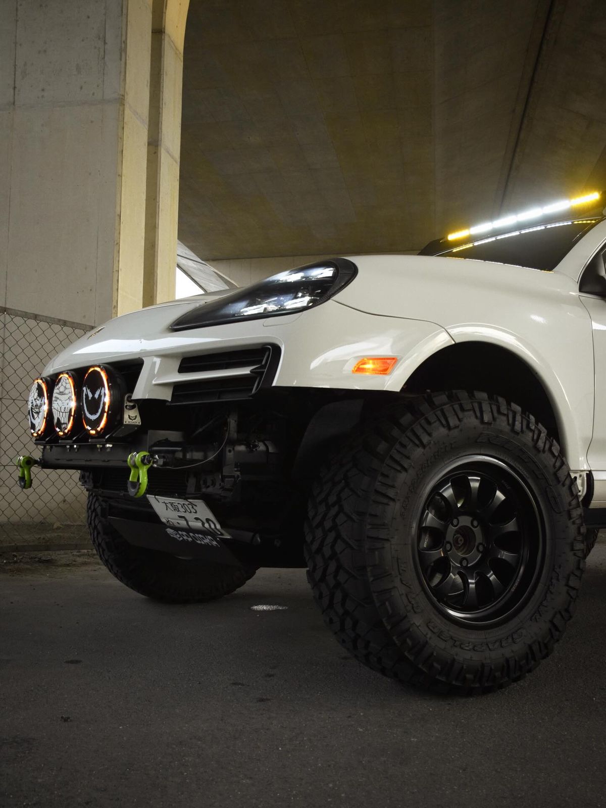 35x12.50R18 Nitto Trail Grappler M/T tires on the white Porsche Cayenne at night