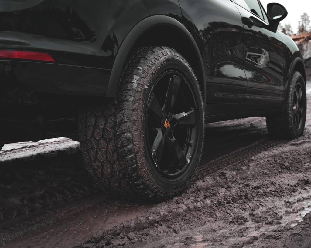 Staggered Porsche 991 wheels wrapped in All terrain tires