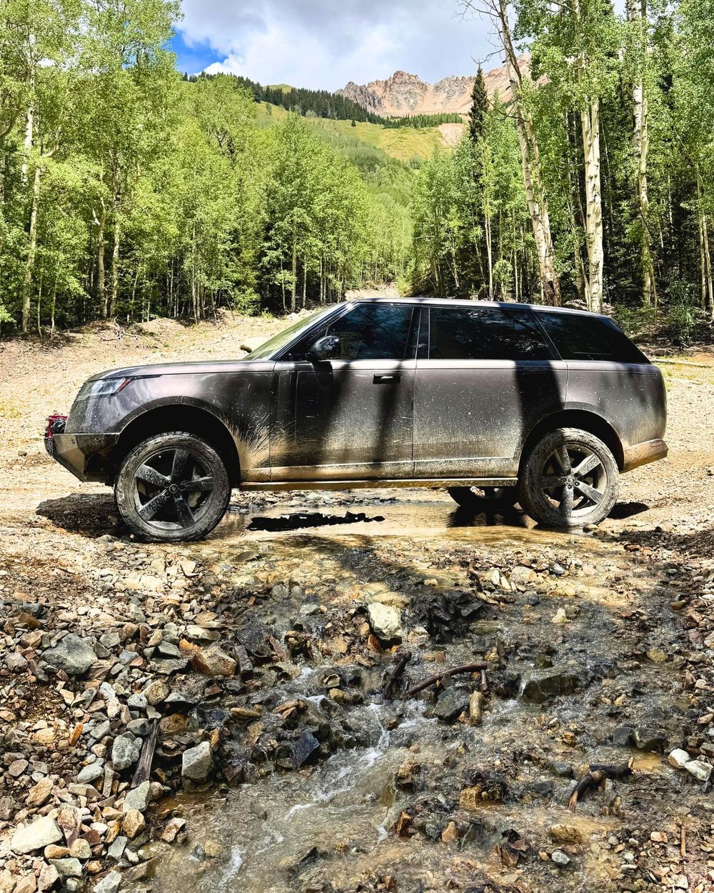 Nitto Recon Grappler 285/50R22 tires on a Range Rover L460 crossing a rocky stream