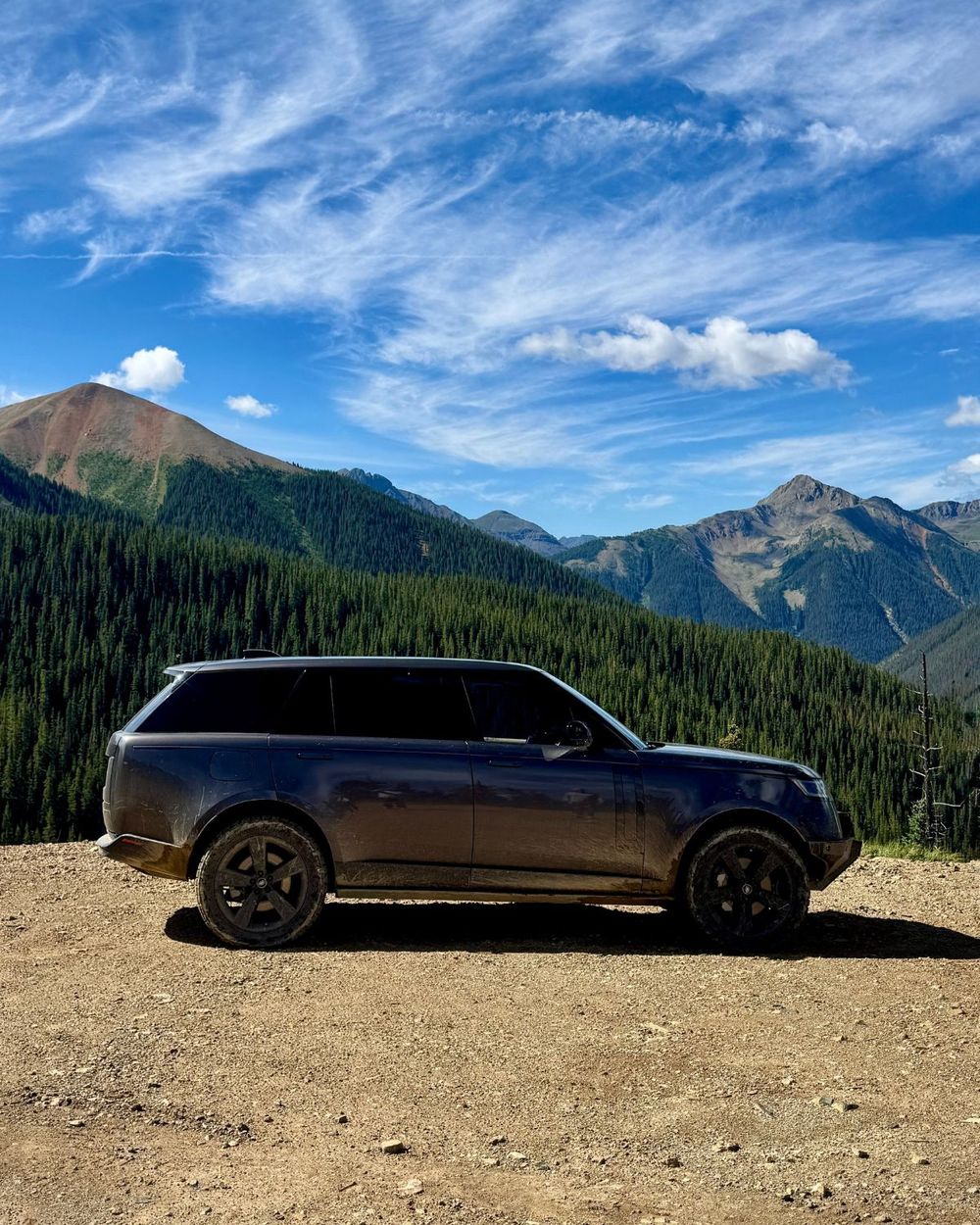 2023 Range Rover L460 in dark gray parked on a high mountain dirt road