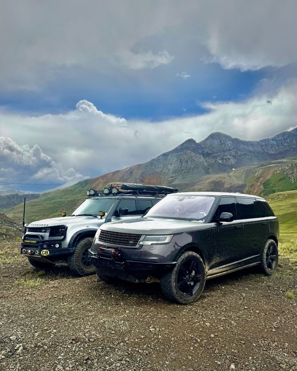 Range Rover L460 with Red Winches King Cobra parked beside a lifted Land Rover Defender