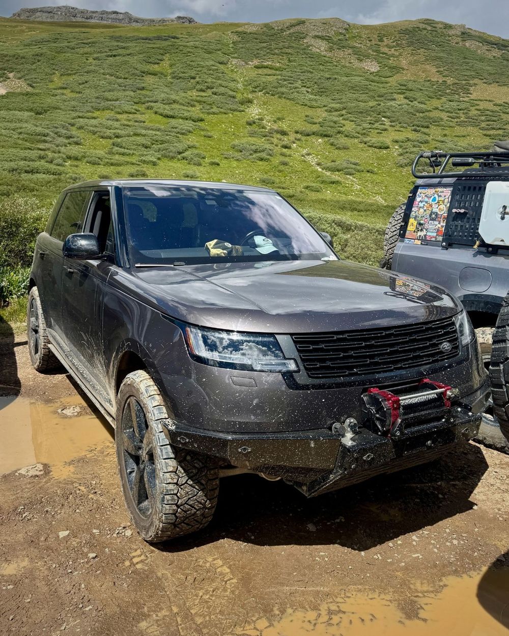 Red Winches King Cobra winch mounted on the front bumper of a muddy Range Rover L460