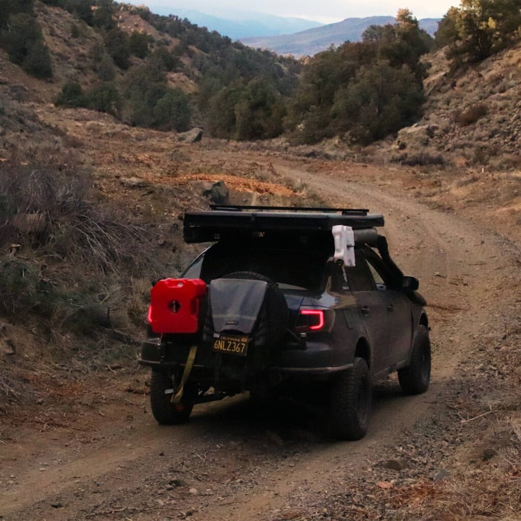 Custom rear bumper holds two 3 gallon Rotopax and a full-size spare