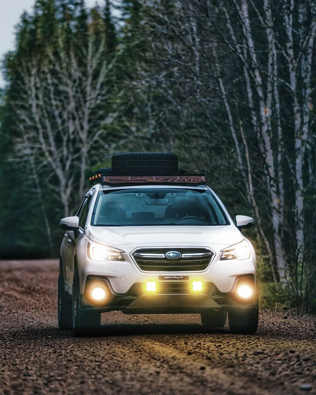 Subaru Outback driving in the forest