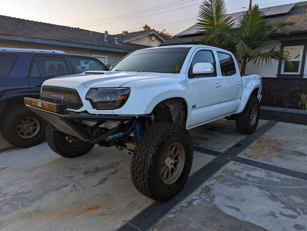 White toyota tacoma prerunner with blacked out headlights