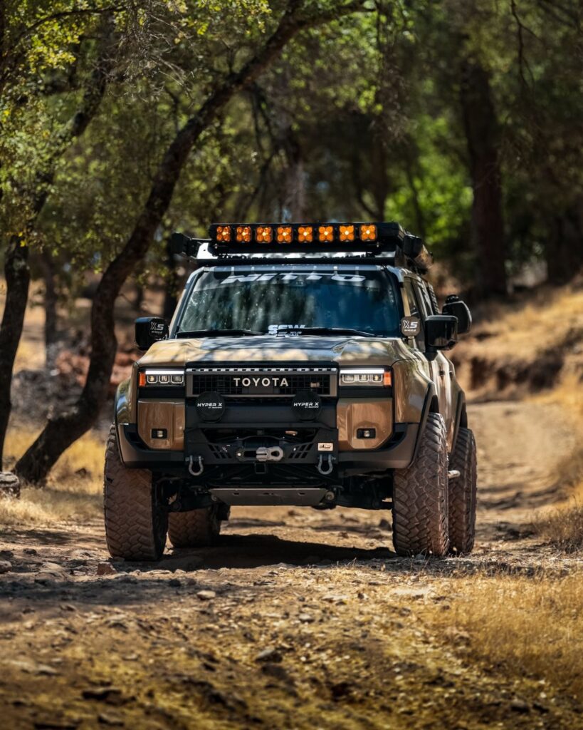 Lifted Toyota Land Cruiser 250 overland suv wheeling in the forest