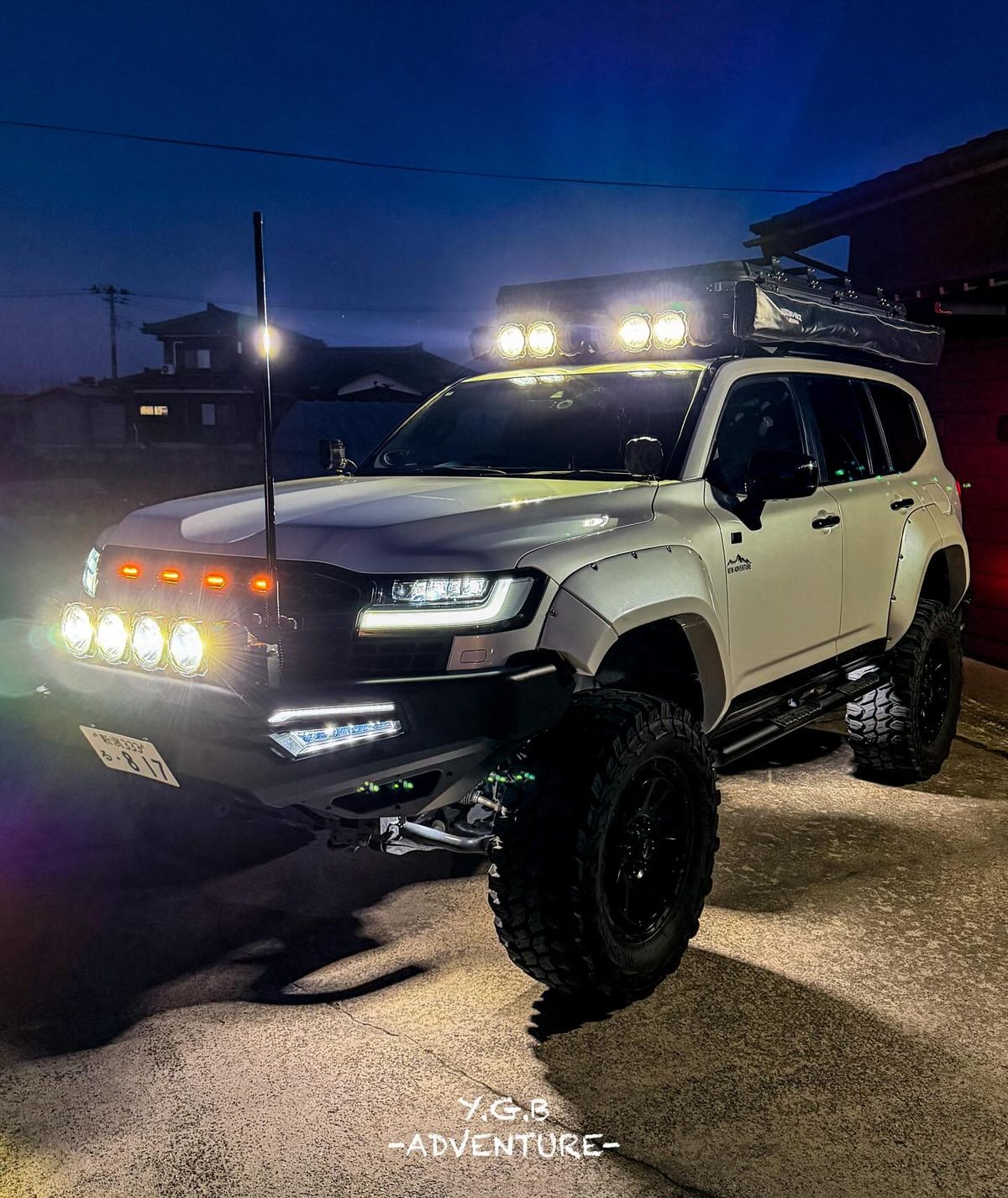 Lifted Toyota Land Cruiser 300 Series at night with KC HiLiTES driving lights mounted on front bumper