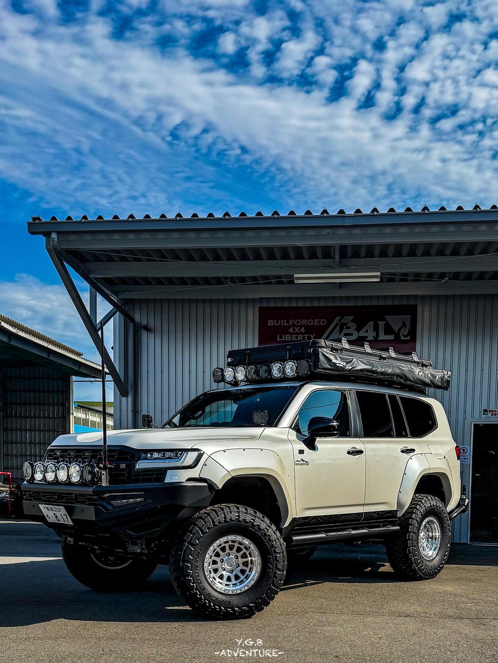 White Toyota Land Cruiser 300 with Freespirit Recreation roof rack loaded with overland gear