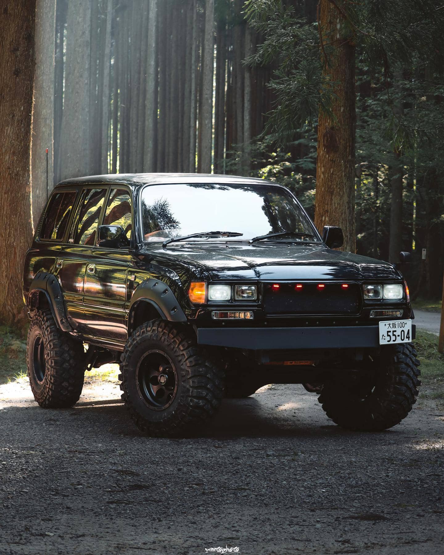 Blacked out toyota Land Cruiser FJ 80 with amber turn signals