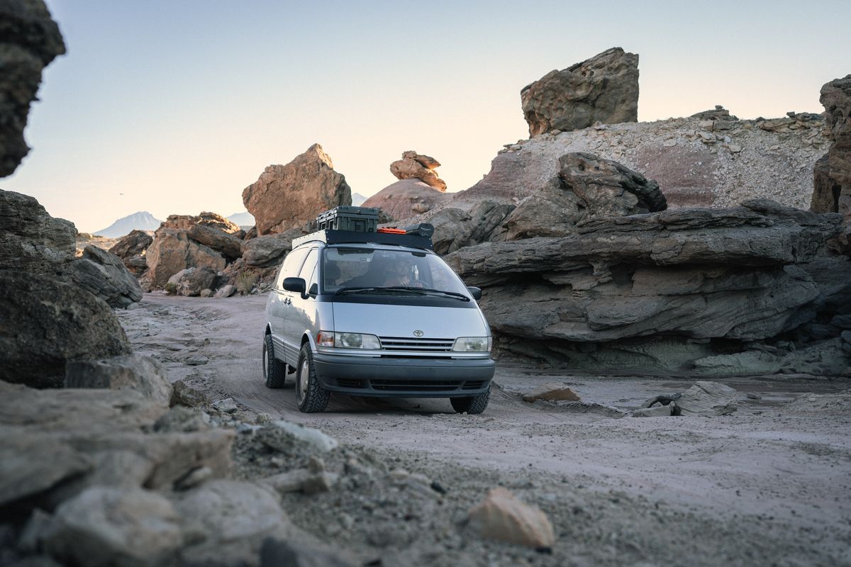 Toyota Previa with Journey's Offroad spacer lift kit navigating a rocky desert trail at dusk