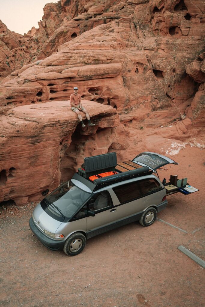 Toyota Previa overland van with recovery boards on roof rack parked at Valley of Fire Nevada