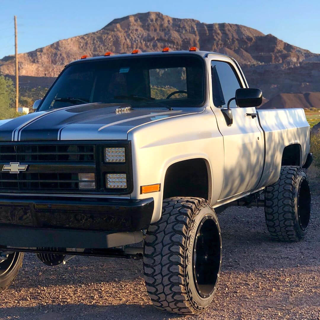 lifted chevy squarebody truck with 24x14 rims