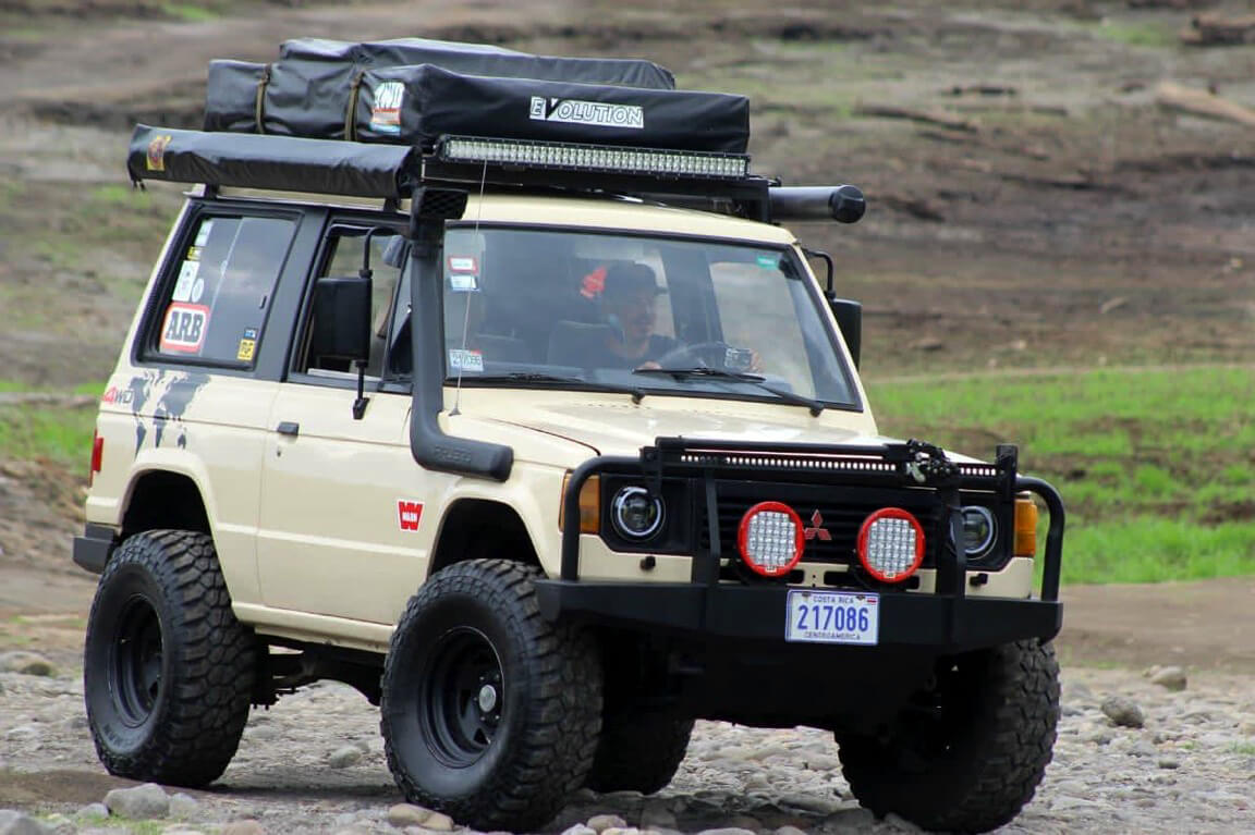 Tan Mitsubishi Montero with a 3 inch lift and off-road accessories