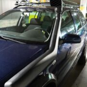 A giant snake-looking Toyota Hilux snorkel sticks out from the passenger side fender, feeding fresh air into the 1.9L turbocharged diesel engine famous for its reliability and low-end torque.