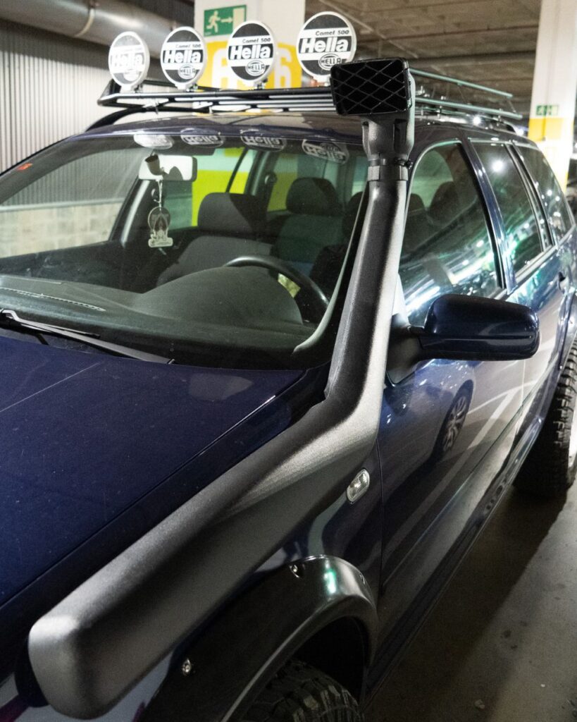 A giant snake-looking Toyota Hilux snorkel sticks out from the driver side fender, feeding fresh air into the 1.9L turbocharged diesel engine.