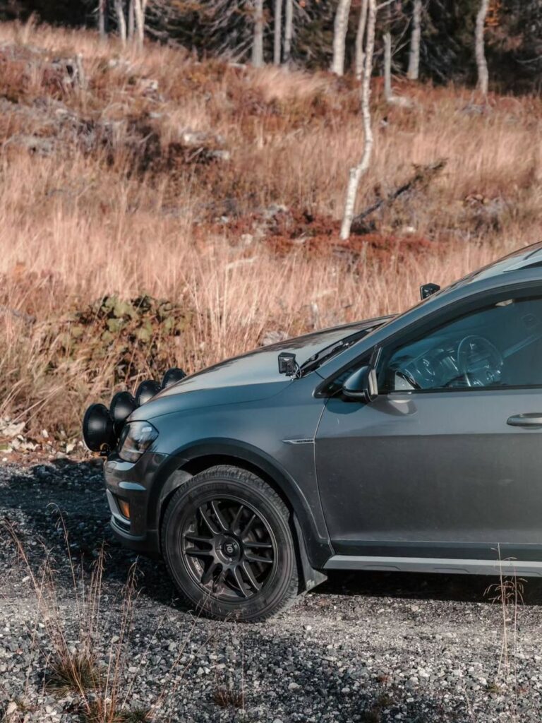 Lifted VW Golf Alltrack wagon with Sparco Tarmac wheels and Strands LED light bar on gravel trail
