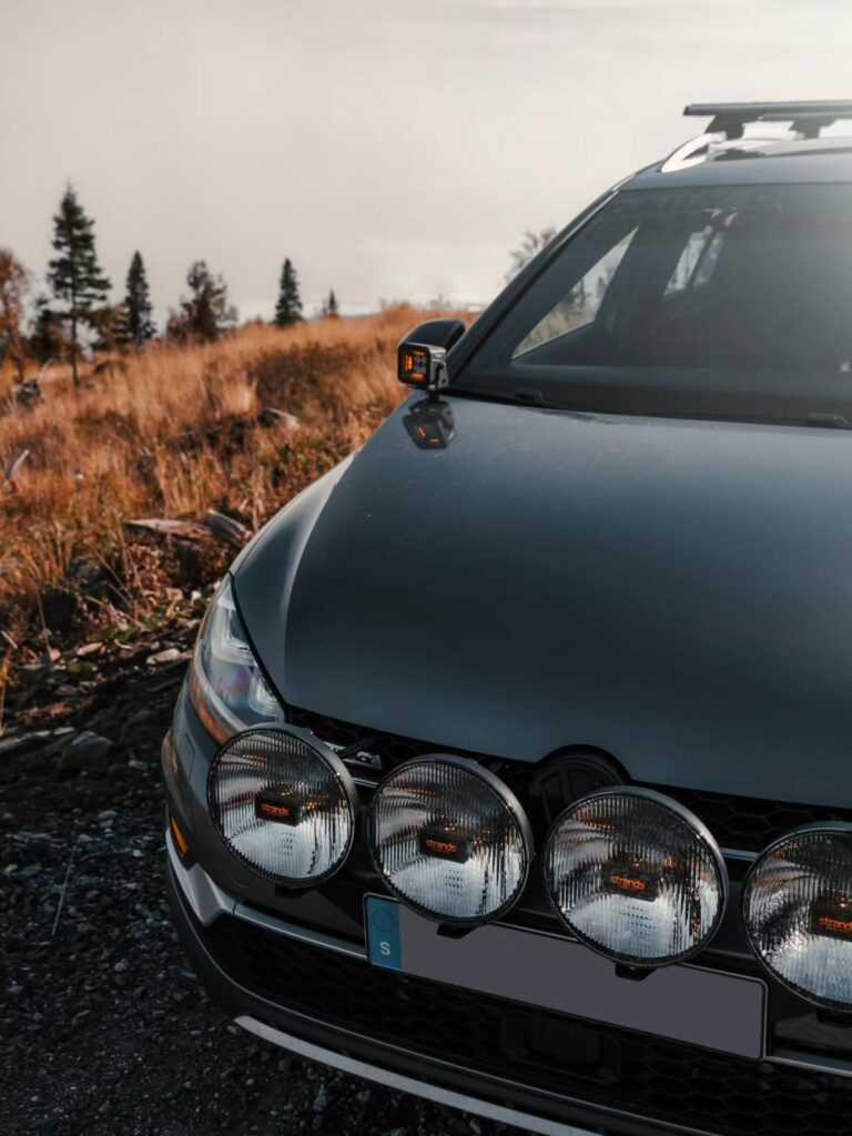 Lifted VW Golf Alltrack with Strands LED light bar setup and rally lights mounted on front bumper for off-road build