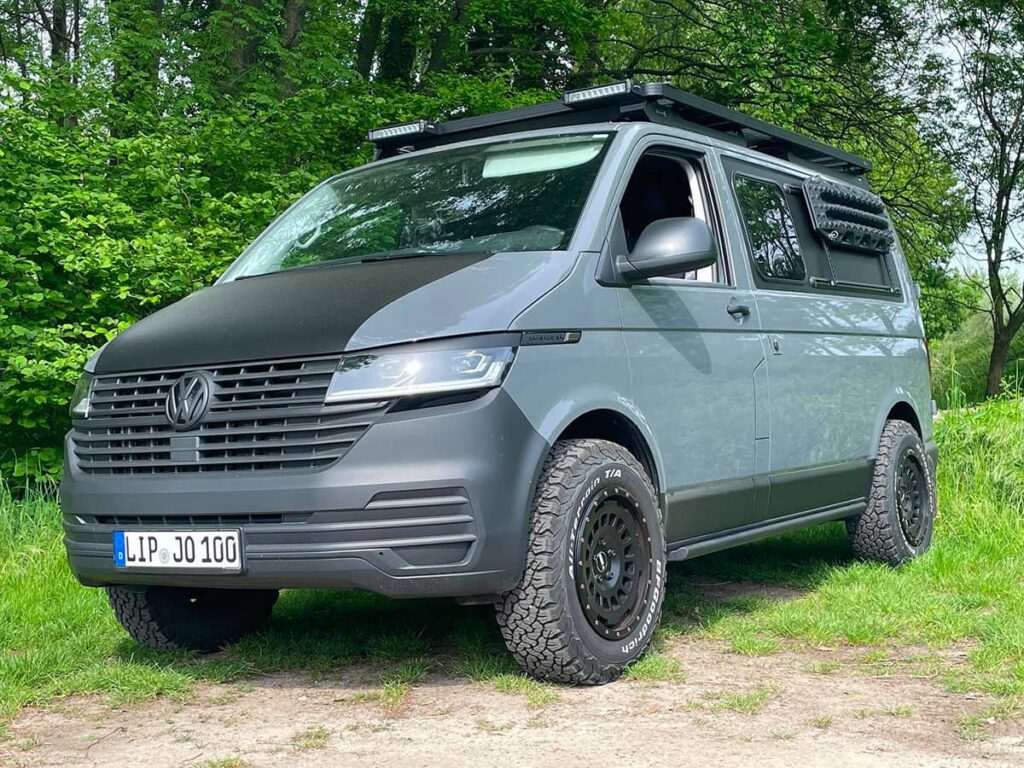 VW transporter T6 modified for offroading with lifted suspension and A/T tires in Germany